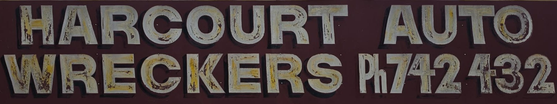 The hand painted Harcourt Auto Wreckers sign